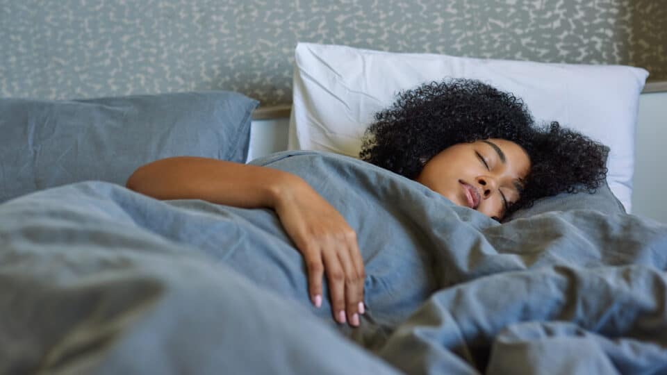 Shot Of A Young Woman Sleeping In Her Bed At Home