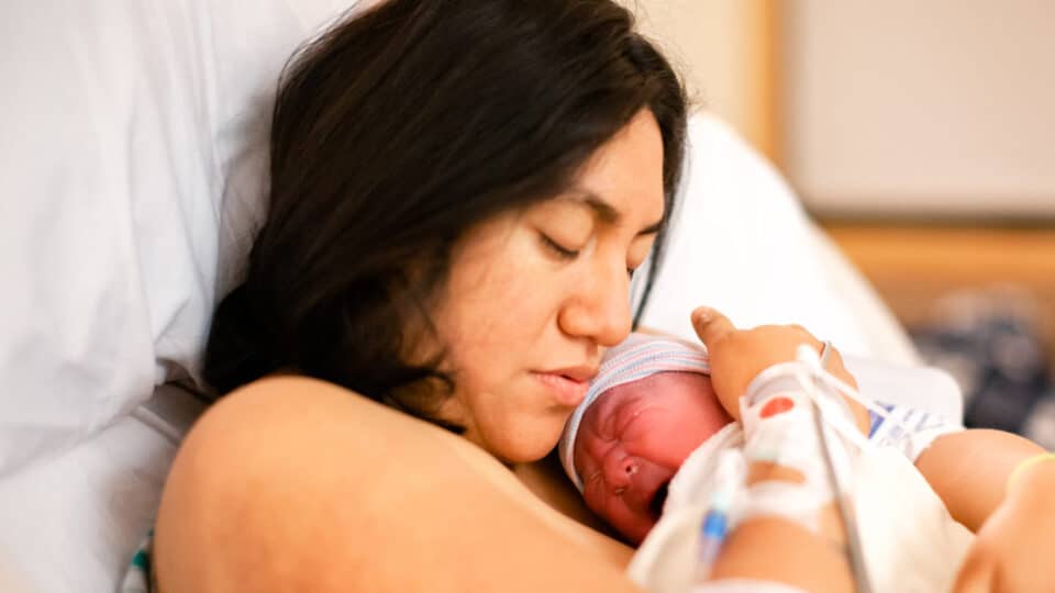 Mother Holding Newborn Daughter In A Hospital