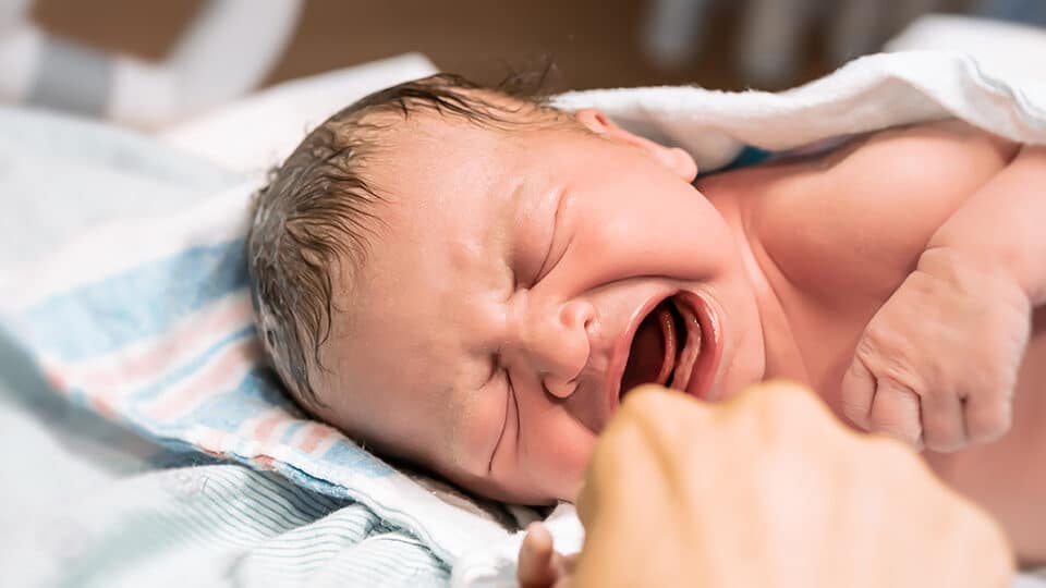 New Mom Holds Her Baby In The Hospital