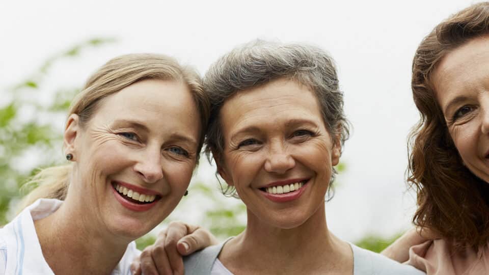 Happy Mature Women Standing In Park