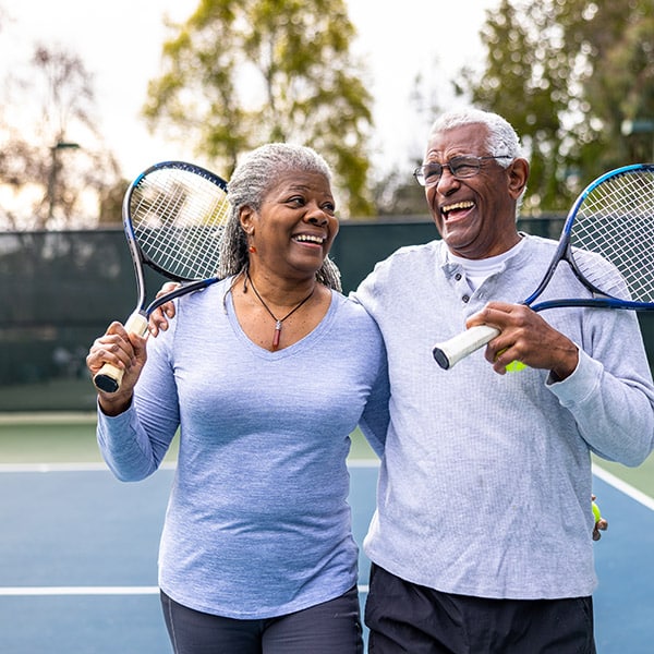 Senior Black Couple Walking Off The Tennis Court