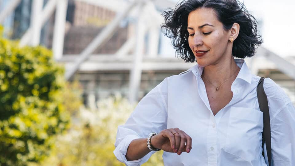 Businesswoman Checking The Time In The Street