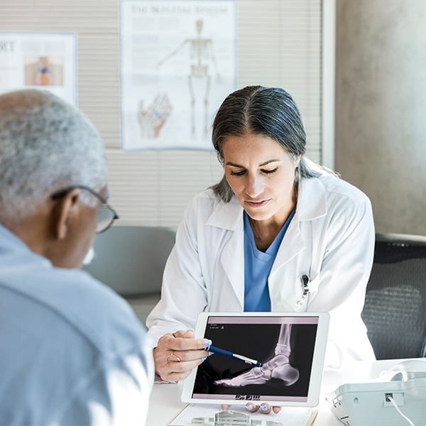 CRMC provider explains an x-ray to her patient.