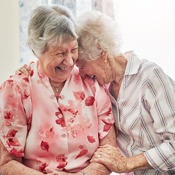 Two elderly women enjoying their friendship.