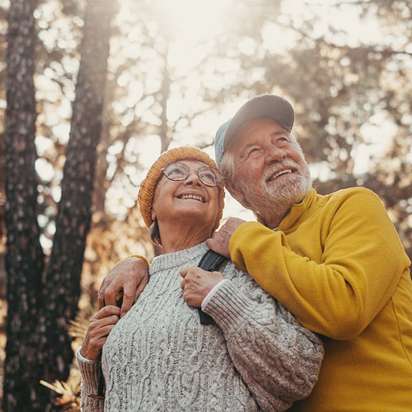 Elderly couple enjoying a hike together.