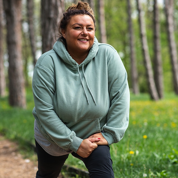 Woman stretches after her run outdoors.