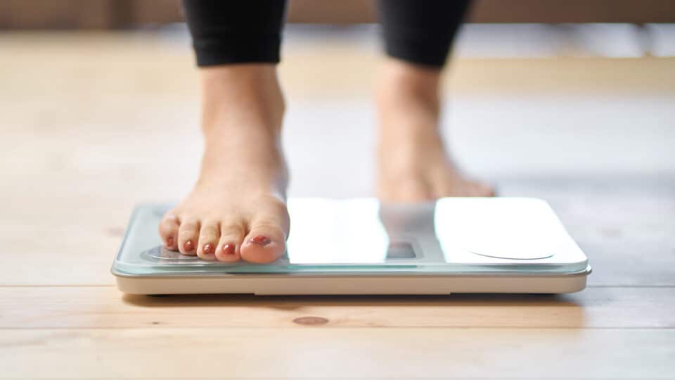 Feet Of An Asian Woman On A Weight Scale