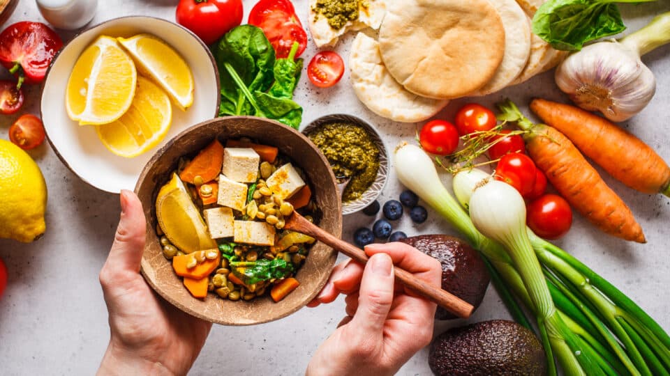 Healthy Vegetarian Food Background. Vegetables, Pesto And Lentil Curry With Tofu.