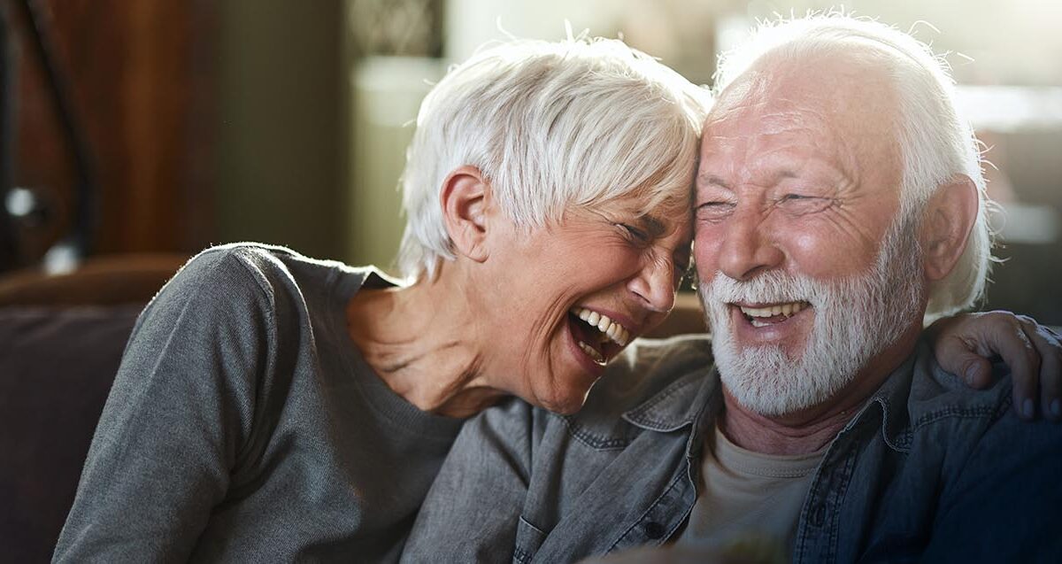 Cheerful Senior Couple Having Fun While Laughing At Home.